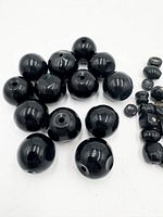 Group of large round black beads