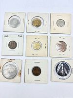 Front view of nine coins in flips