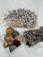 Three bags of assorted beads laid out