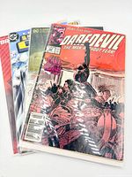 Stack of three bagged comic books showing Daredevil #252 on top