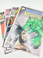 Four bagged Marvel comic books fanned out, showing cover titles