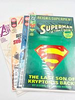 Stack of four bagged comic books