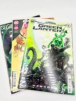 Three bagged comic books fanned out showing titles