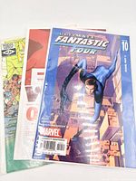 Stacked view of three bagged comics showing all titles