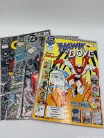 Four Hawk & Dove comic books fanned out