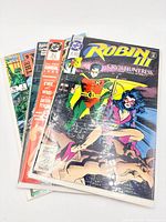 Stack of four bagged comic books, Robin III #3 on top