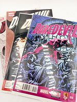 Three Daredevil comics stacked, showing covers and protective sleeves