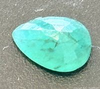 Pear-cut green gemstone front view