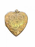 Front view of heart-shaped gold-filled locket showing floral scroll and rose pattern