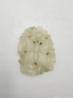 Front view of nephrite plaque showing carved leaves and flowers