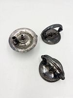 Top view of three silverplated parts