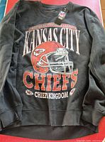 Full view of black Kansas City Chiefs sweatshirt front graphic