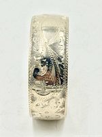 Front view of engraved sterling silver cuff bracelet