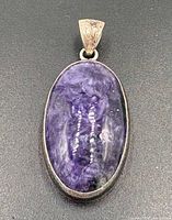 Front view of oval charoite pendant with bail