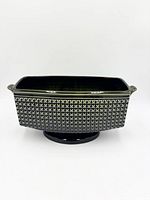 Front view showing geometric pattern, handles, pedestal base