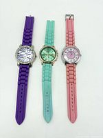 Front view of three watches showing straps and dials