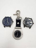 Front view of three watches showing dials and cases