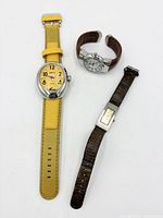 All three wristwatches laid out
