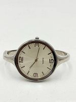 Front view of Wincci silver-tone bangle cuff watch showing dial, numerals and bezel