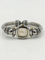Front view showing square dial and decorative cuff ends