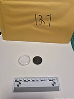 Coin and capsule with scale reference