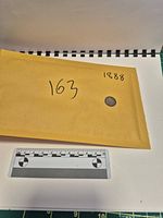 Coin beside envelope and scale