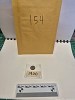 Full lot with envelope number, coin in sleeve