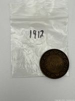 Reverse of 1912 Canadian large cent in labelled zip bag