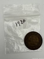 Coin front showing reverse legend and bag marked 1920