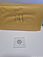 Coin in holder with envelope background