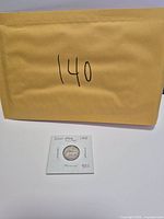 Coin in cardboard flip with envelope background