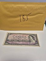 Obverse of 1954 $10 banknote with envelope behind