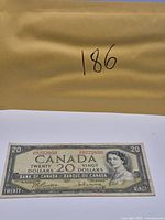 Full view of banknote with envelope bearing lot reference number