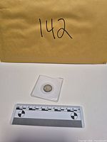 Coin in holder with scale reference