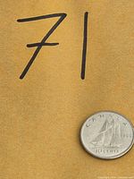 Oblique view of entire coin beside reference number