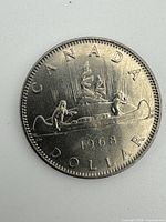 Reverse showing Voyageur canoe design and 1968 date