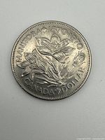 Reverse of 1970 Manitoba centennial dollar showing crocus design