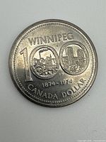Reverse of 1974 Winnipeg Centennial dollar coin showing "WINNIPEG 100" design