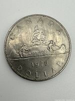 Reverse side showing Voyageur canoe design and 1975 date