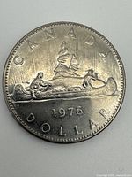 Reverse showing Voyageur canoe design and date 1976