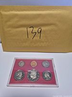 Front view of acrylic holder showing six 1980 U.S. coins