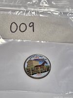 Coin in plastic bag showing colorized reverse