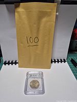 Overall view with envelope and encapsulated coin