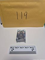 Front of sealed box with colourized silver bar artwork and scale
