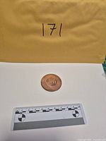 Copper round with scale and envelope