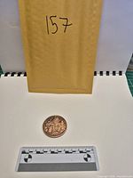 Overall lot with copper round and reference envelope