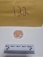 Round in capsule with scale and lot number visible