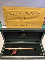 Pen inside open Cross box with wax-seal tag visible