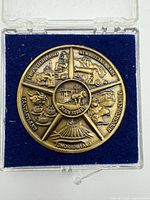 Reverse of medallion showing park land scenes