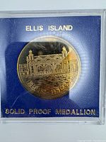 Front view of medallion in holder showing design and inscriptions